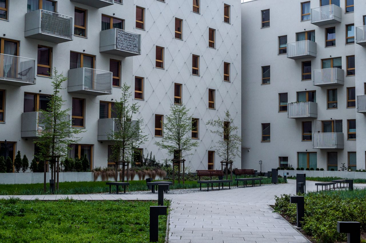 About Contemporary apartment complex with landscaped courtyard and balconies.